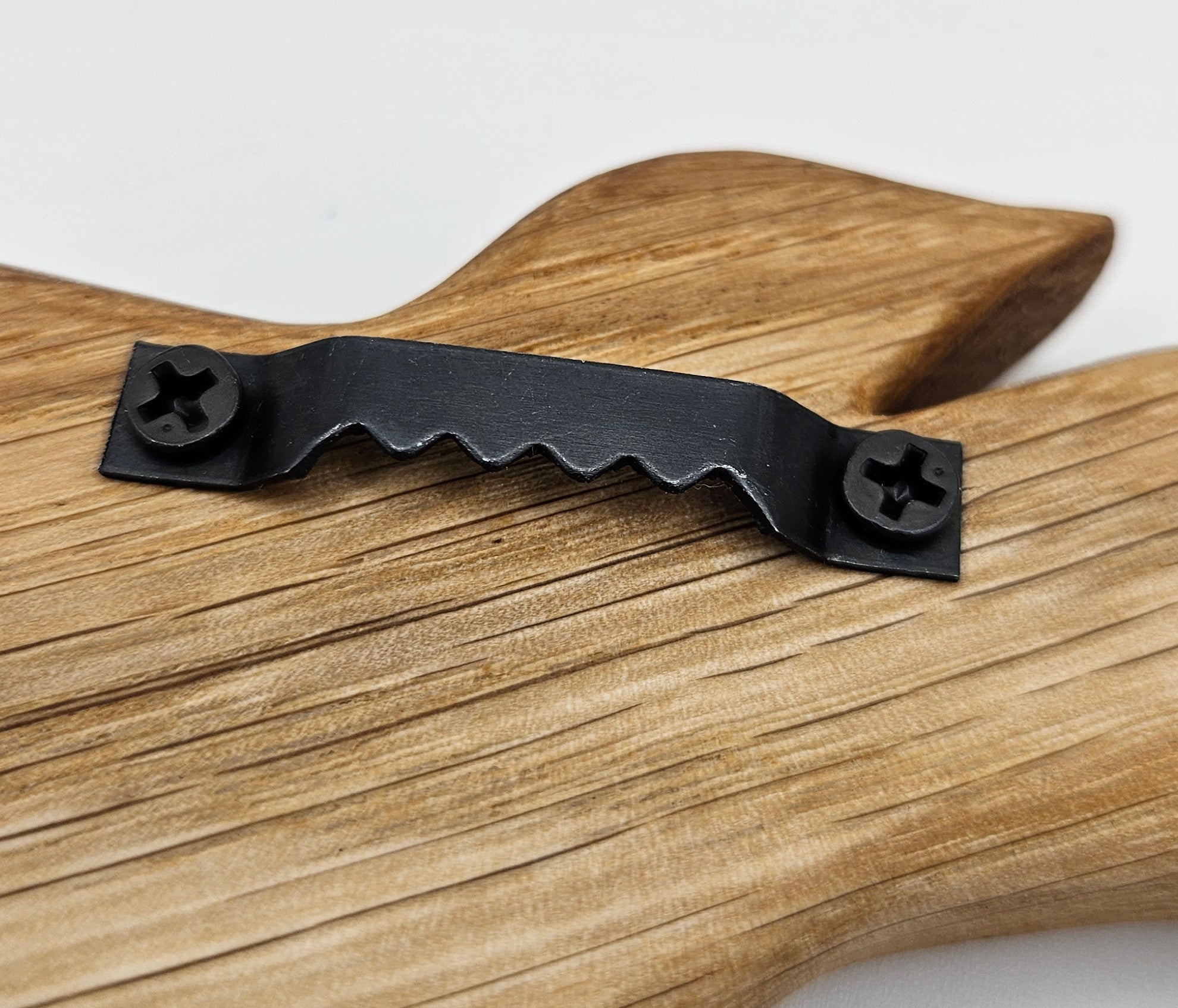 schwarzer Zackenaufhäng an der Rckseite eines Holzvogels