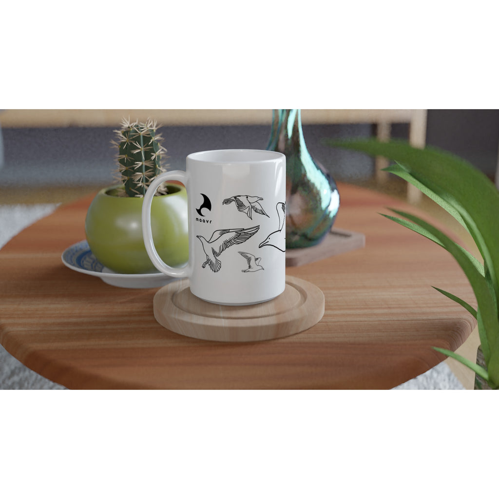 Weiße XL-Tasse mit Line Art Möwen  auf Holztisch arrangiert mit Kaktus und Vase